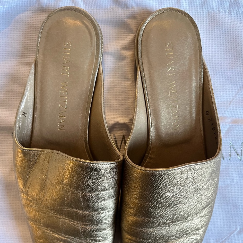 Stuart Weitzman, gently worn gold metallic mules in a size 6.